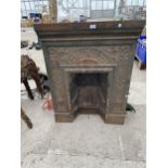 A DECORATIVE CAST IRON FIRE PLACE SURROUND