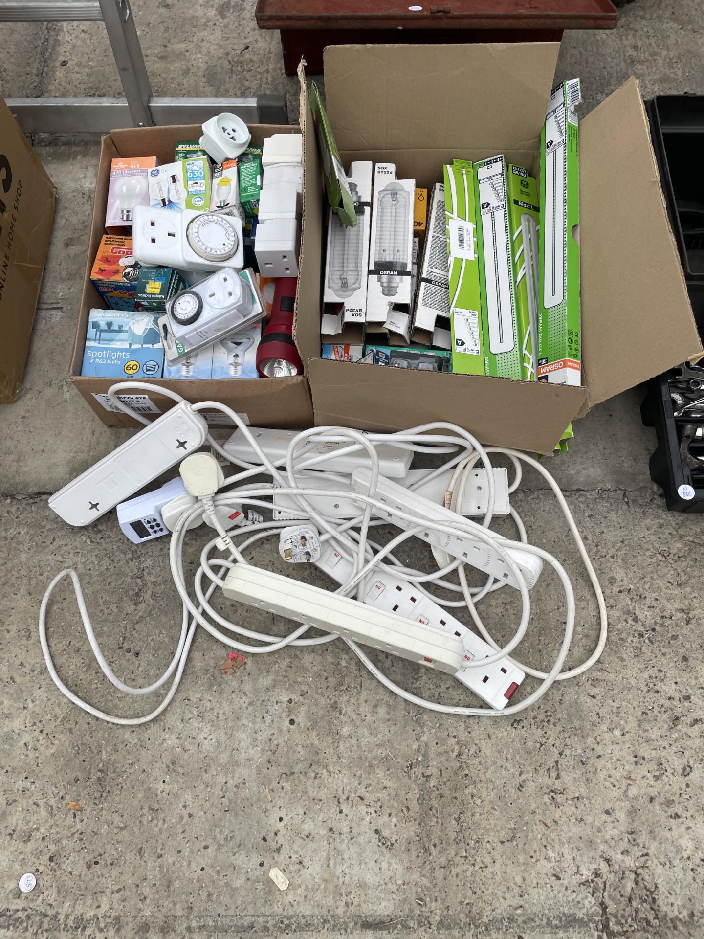 TWO BOXES OF AS NEW LIGHT BULBS AND A COLLECTION OF EXTENSION CABLES