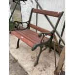 A WOODEN SLATTED GARDEN SEAT WITH DECORATIVE CAST ENDS