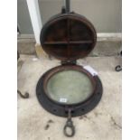 A VINTAGE AND DECORATIVE CAST IRON PORTHOLE