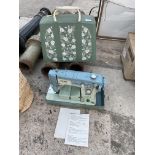 A RETRO JONES SEWING MACHINE WITH CARRY CASE