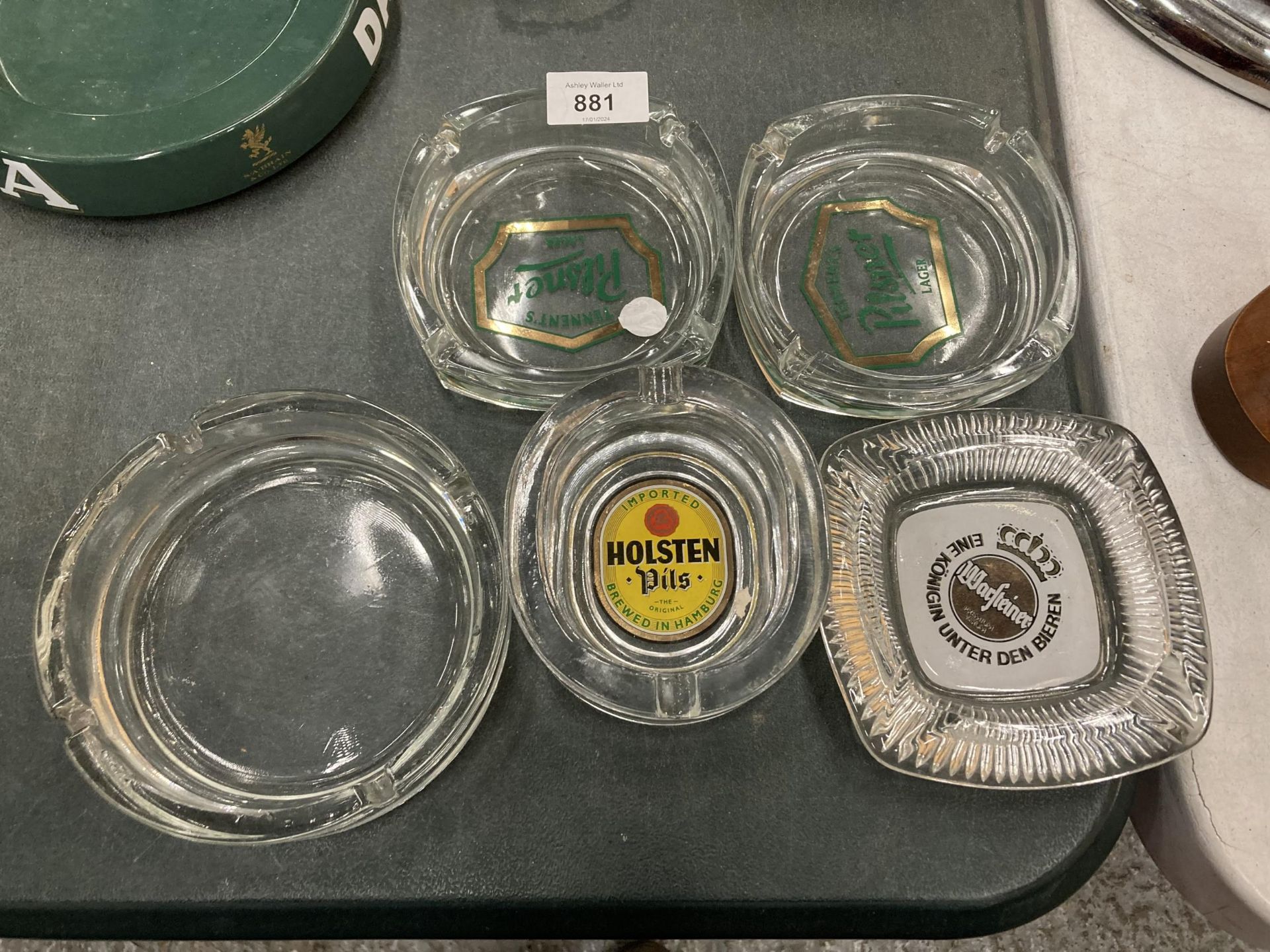 FIVE GLASS ASHTRAYS TO INCLUDE HOLSTEN, PILSNER AND WARSTEINER