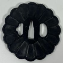 A JAPANESE IRON TSUBA WITH FLUTED DESIGN, DIAMETER 8 CM