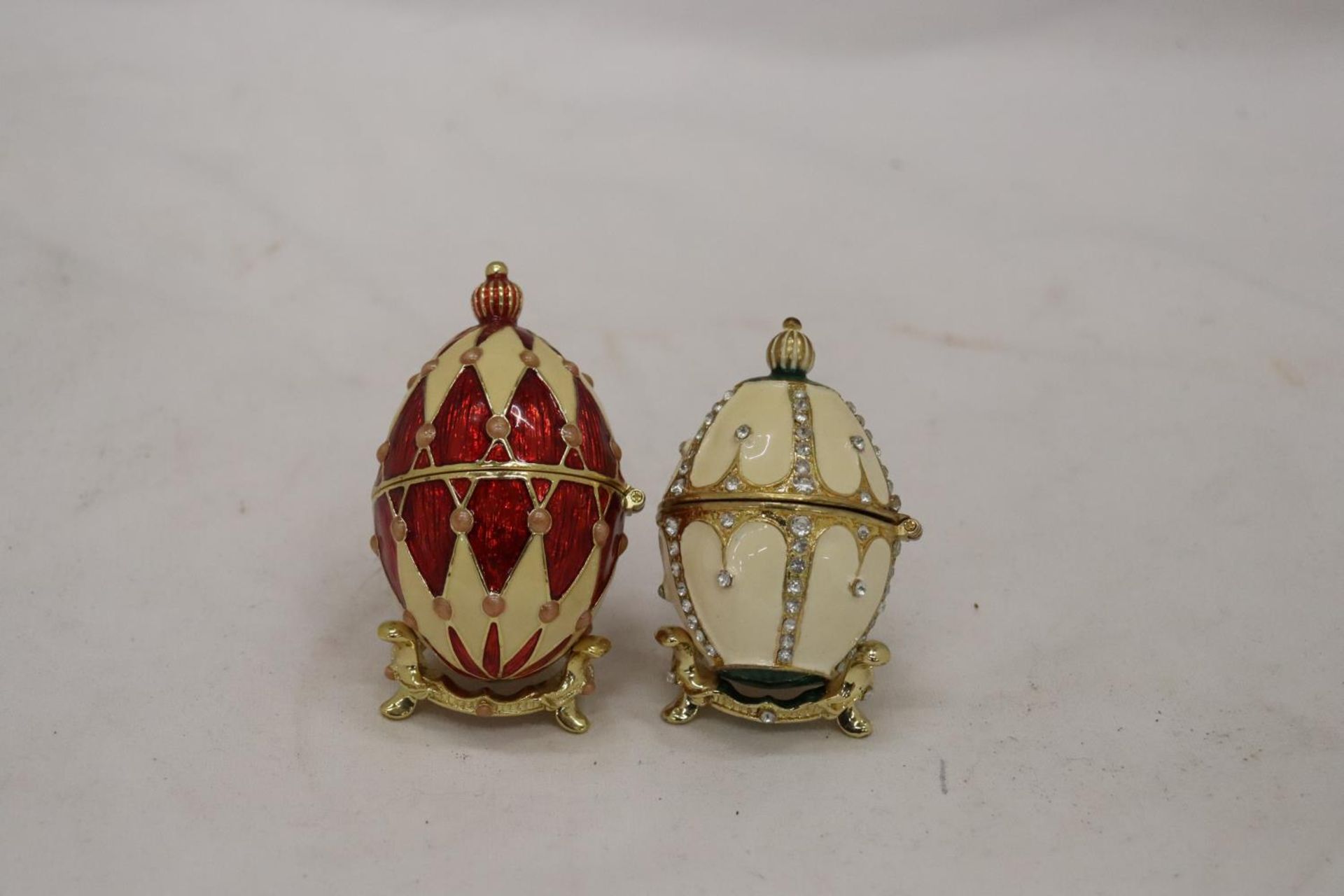 TWO DECORATIVE ENAMELLED EGG TRINKET BOXES ON STANDS