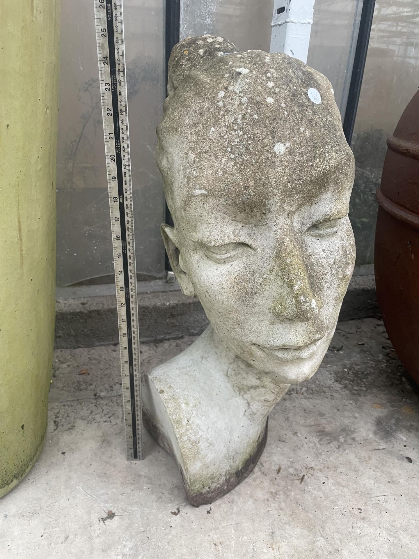 A RECONSTITUTED STONE GARDEN FIGURE OF A FEMALE BUST (H:65CM)
