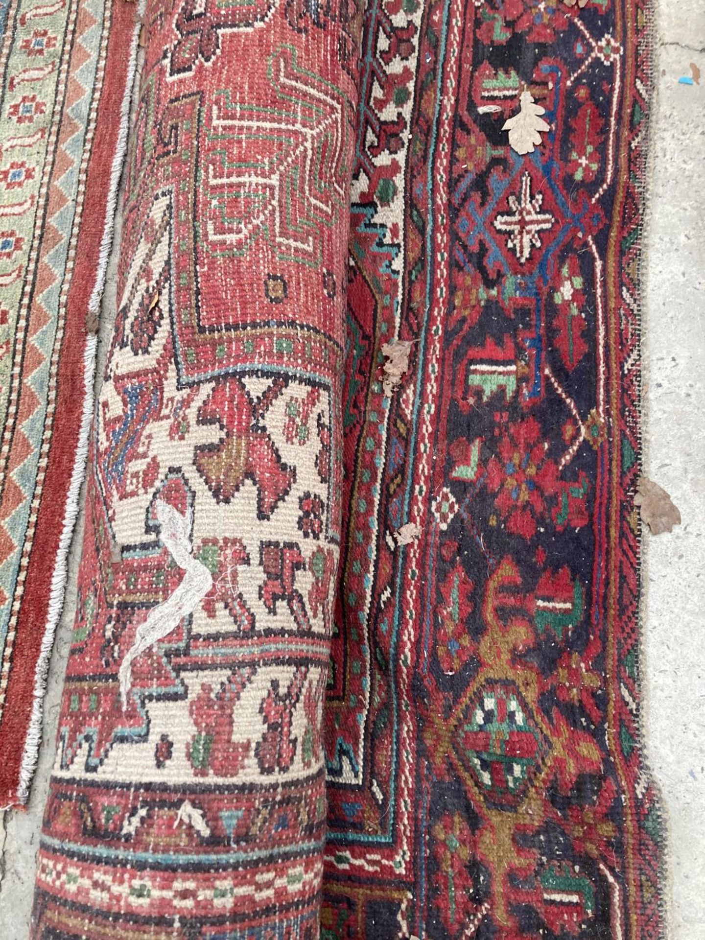 A LARGE RED PATTERNED FRINGED RUG - Image 2 of 2