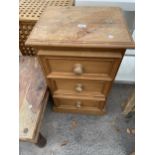 A PINE BEDSIDE CHEST OF THREE DRAWERS