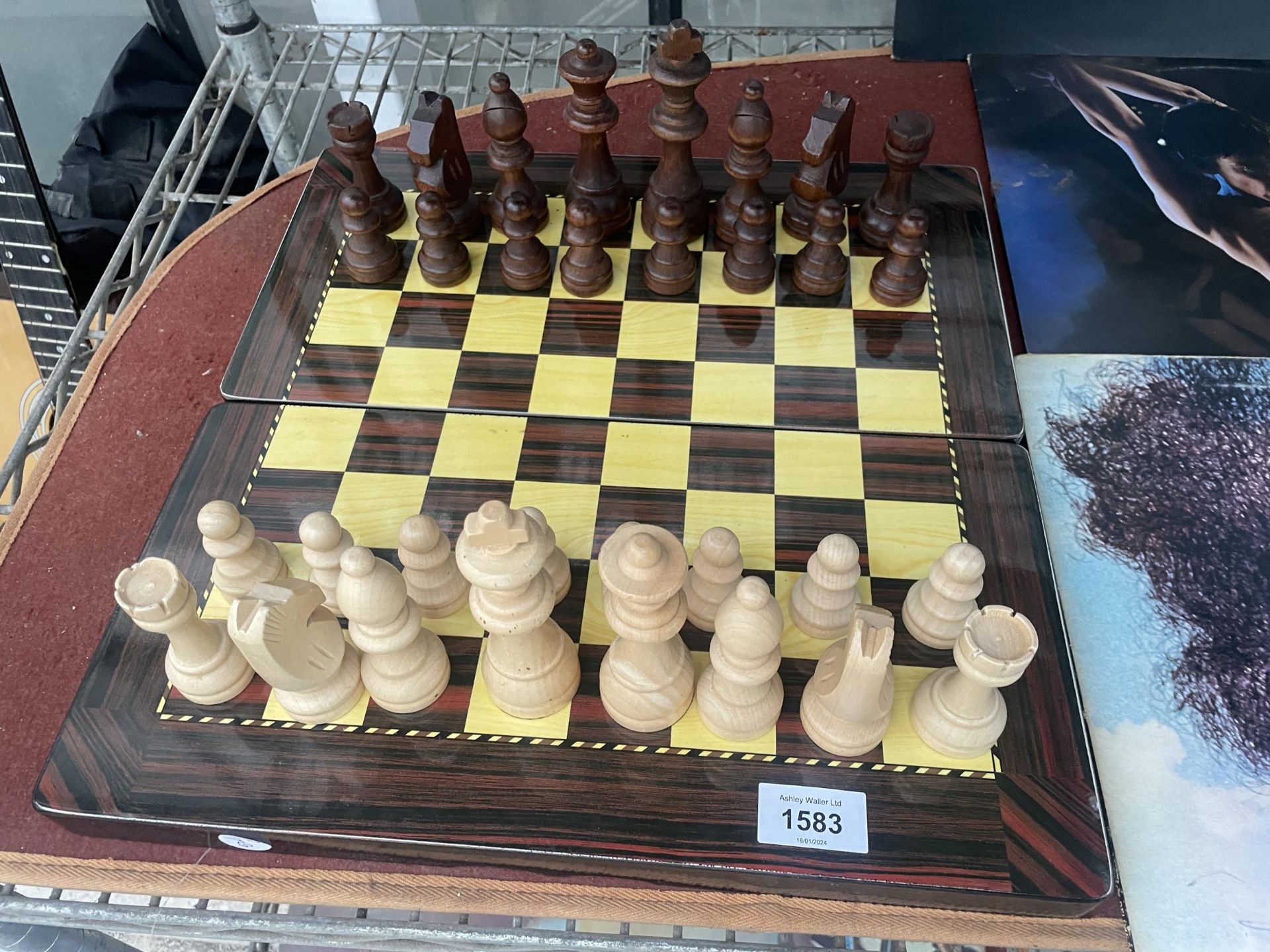 A FOLDING CHESS BOARD WITH A FULL SET OF CHESS PIECES