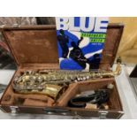 A YAMAHA SAXOPHONE WITH CASE AND A TEACHING BOOK