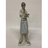 A LLADRO STYLE LADY FIGURE HOLDING A LAMB