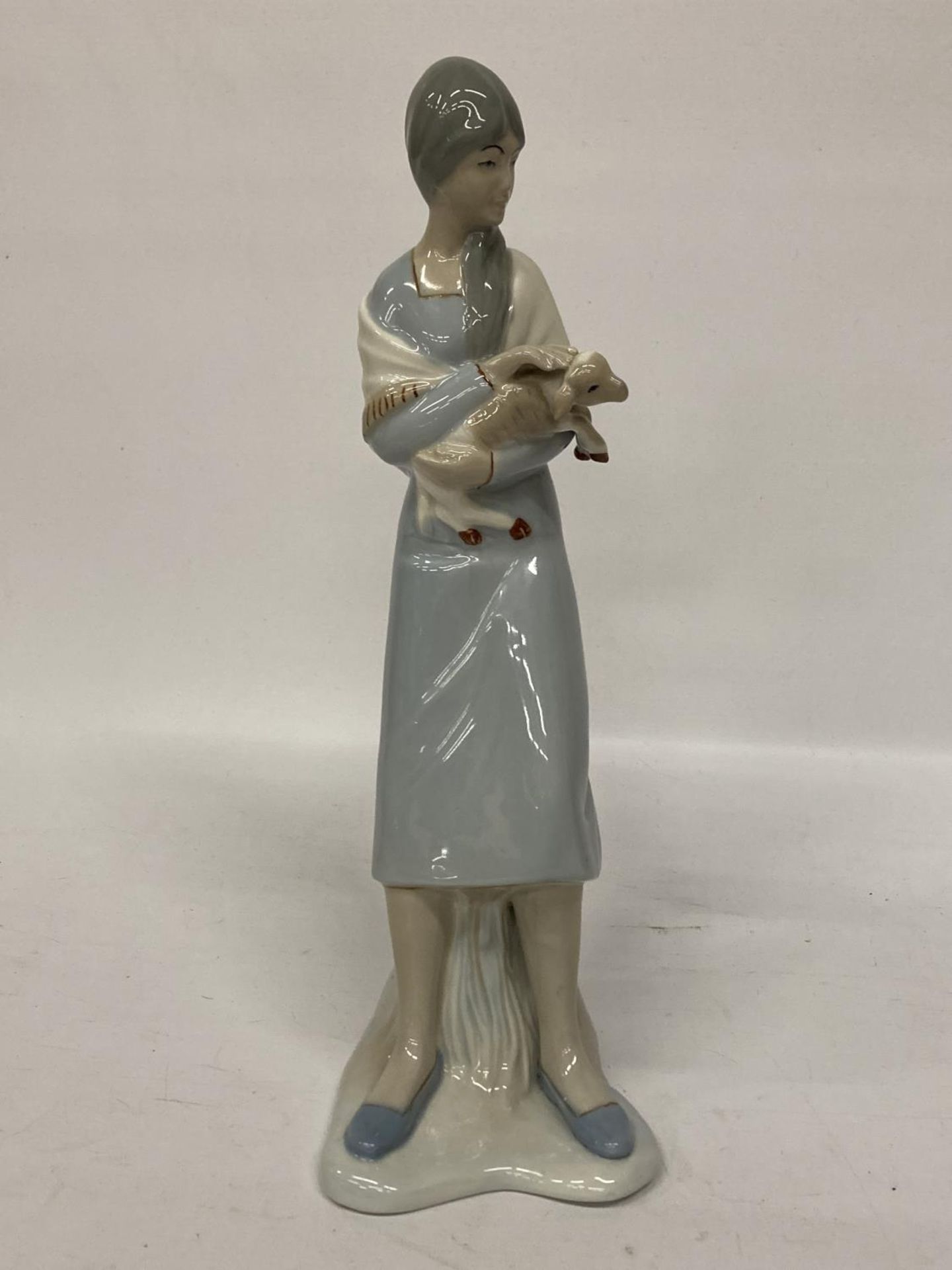 A LLADRO STYLE LADY FIGURE HOLDING A LAMB