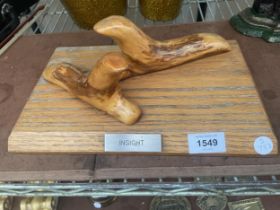 A PAIR OF ABSTRACT WOODEN CARVINGS ON A WOODEN PLINTH, TITLED 'INSIGHT'