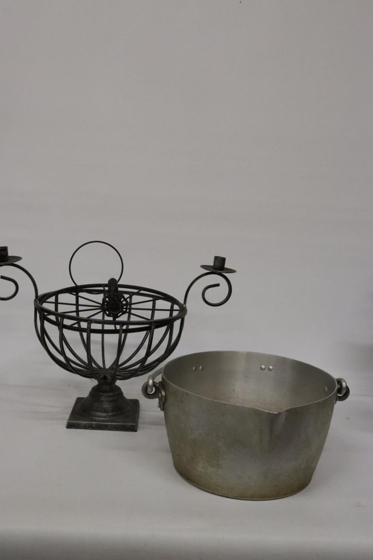 A JAM PAN AND A METAL PLANT HOLDER WITH CANDLESTICKS