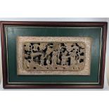 A CHINESE LACQUERED AND GILT CARVED WOODEN PANEL, ON LATER GREEN LEATHER MOUNT AND WOODEN FRAME,