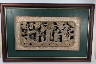 A CHINESE LACQUERED AND GILT CARVED WOODEN PANEL, ON LATER GREEN LEATHER MOUNT AND WOODEN FRAME,