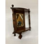 A MAHOGANY EDWARDIAN CORNER MIRROR WITH TWO COLUMS AND SHELF APPROX 18' TALL