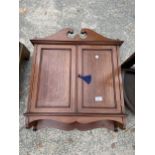 AN EDWARDIAN MAHOGANY AND INLAID TWO DOOR WALL CABINET WITH SWAN NECK PEDIMENT, 24" WIDE