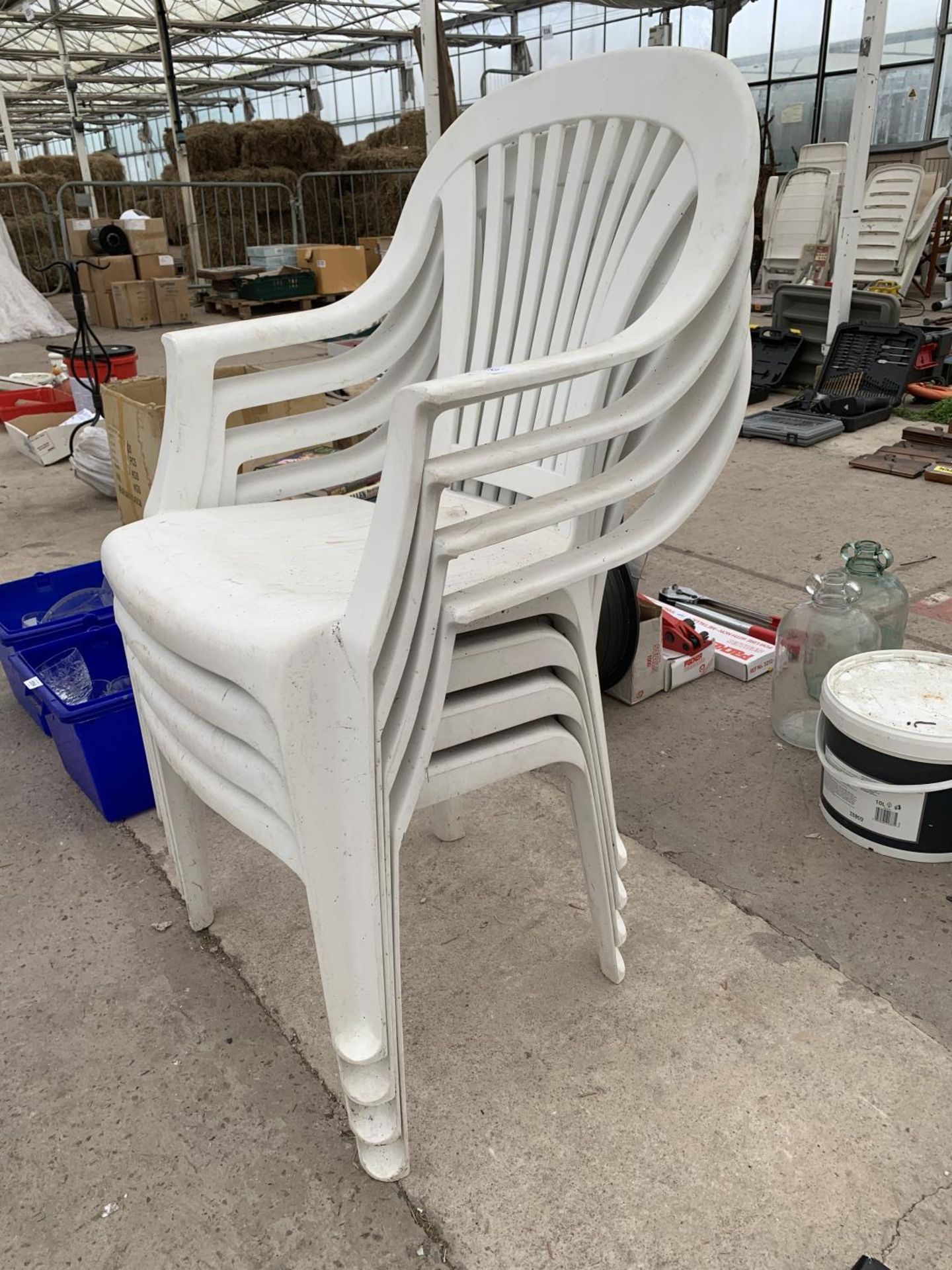 FOUR WHITE PLASTIC STACKING GARDEN CHAIRS