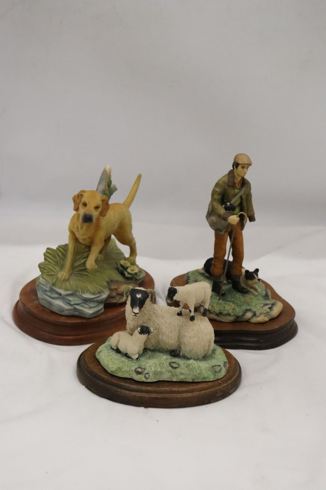 TWO BORDER FINE ARTS FIGURES ON WOODEN BASES TO INCLUDE SHEEP AND A FARMER WITH A SHEEP DOG, BOTH