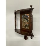 A MAHOGANY EDWARDIAN CORNER MIRROR WITH TWO COLUMS AND SHELF APPROX 18" TALL