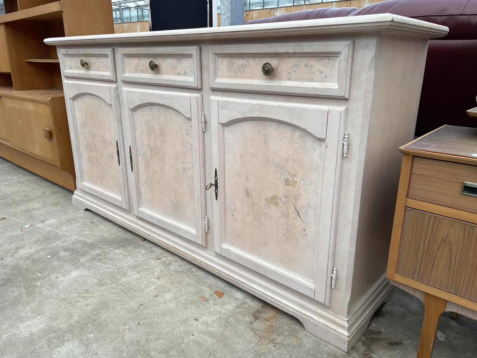 A MODERN PAINTED SIDEBOARD ENCLOSING THREE DRAWERS AND THREE CUPBOARDS, 67" WIDE - Image 2 of 2