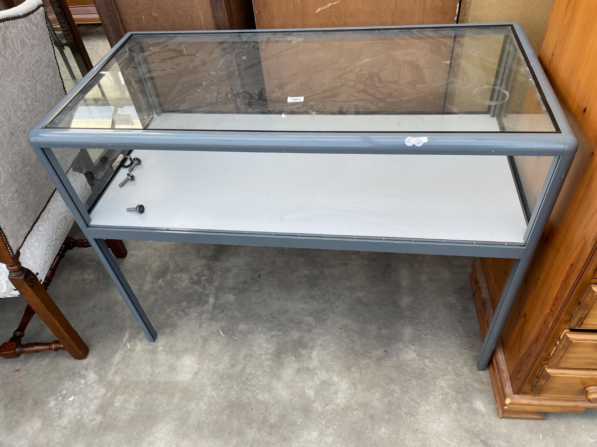 A MODERN METALWARE FRAMED GLASS DISPLAY COUNTER, 47 X 24"