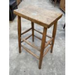 AN ELM AND BEECH STOOL ON TURNED LEGS