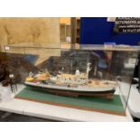 A LARGE MODEL OF A BOAT WITH HELICOPTER IN A GLASS CASE