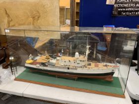 A LARGE MODEL OF A BOAT WITH HELICOPTER IN A GLASS CASE