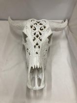A MODEL OF A WHITE COW SKULL WITH HORNS