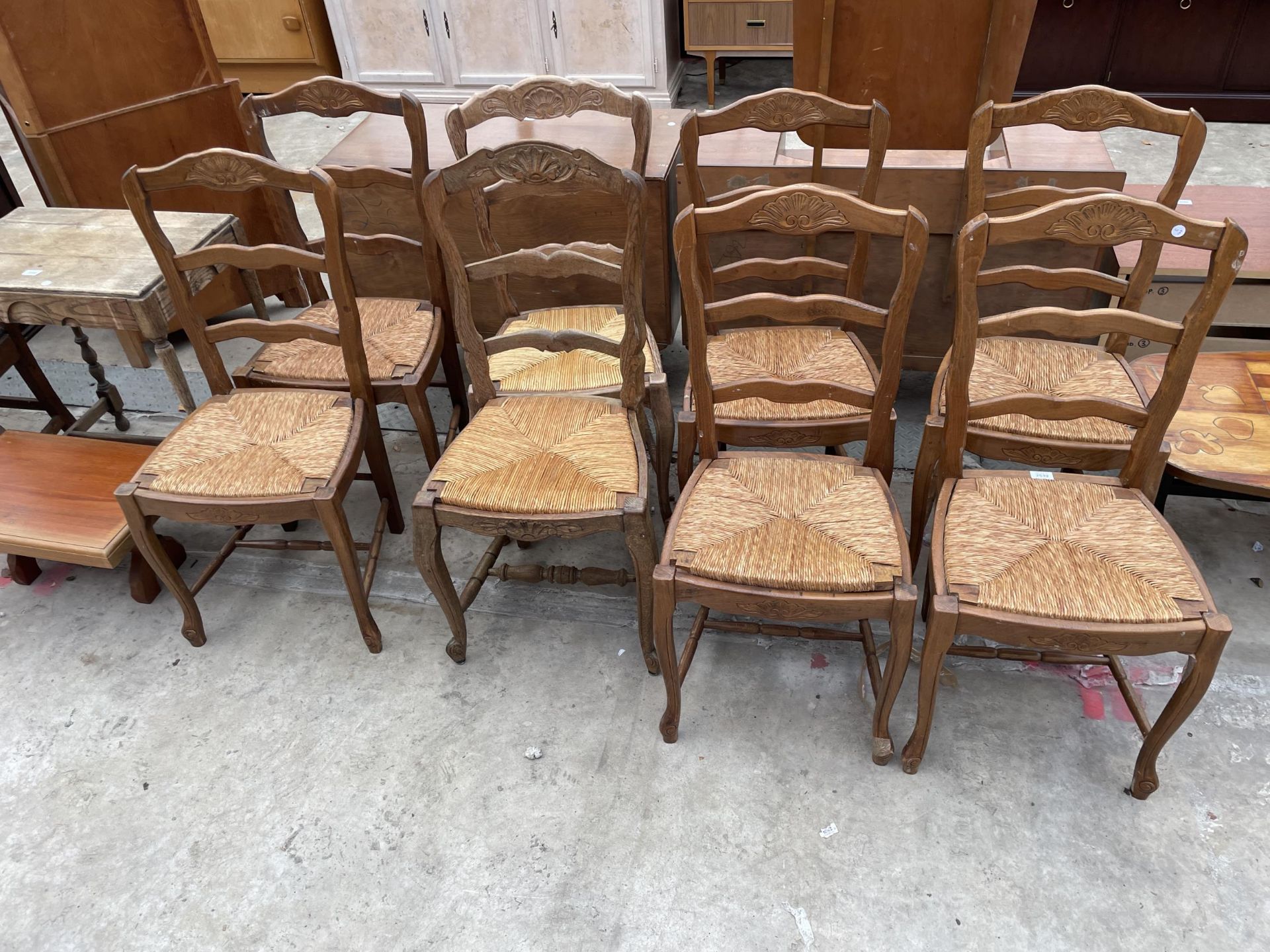 A SET OF EIGHT FRENCH LADDERBACK DINING CHAIRS WITH RUSH SEATS