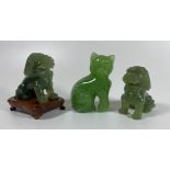 THREE JADE STYLE HARDSTONE ITEMS - PAIR OF CARVED FOO DOGS, ONE ON WOODEN BASE AND A CAT, HEIGHT 7
