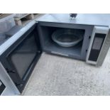 A SILVER KENWOOD MICROWAVE OVEN