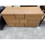 A MODERN OAK EFFECT CHEST OF NINE DRAWERS OF VARIOUS SIZES, 53" WIDE