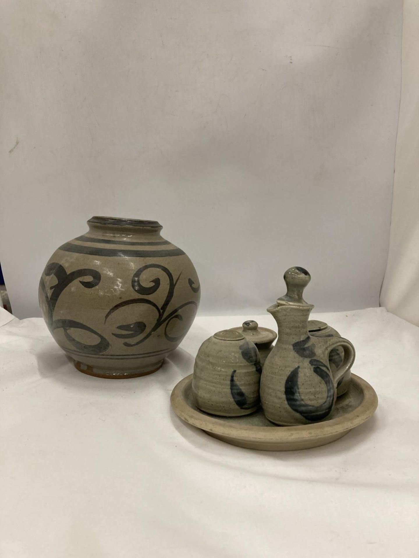 A STUDIO POTTERY BULBOUS VASE, PLATE AND CRUETS WITH MAKERS NAME TO THE BASE
