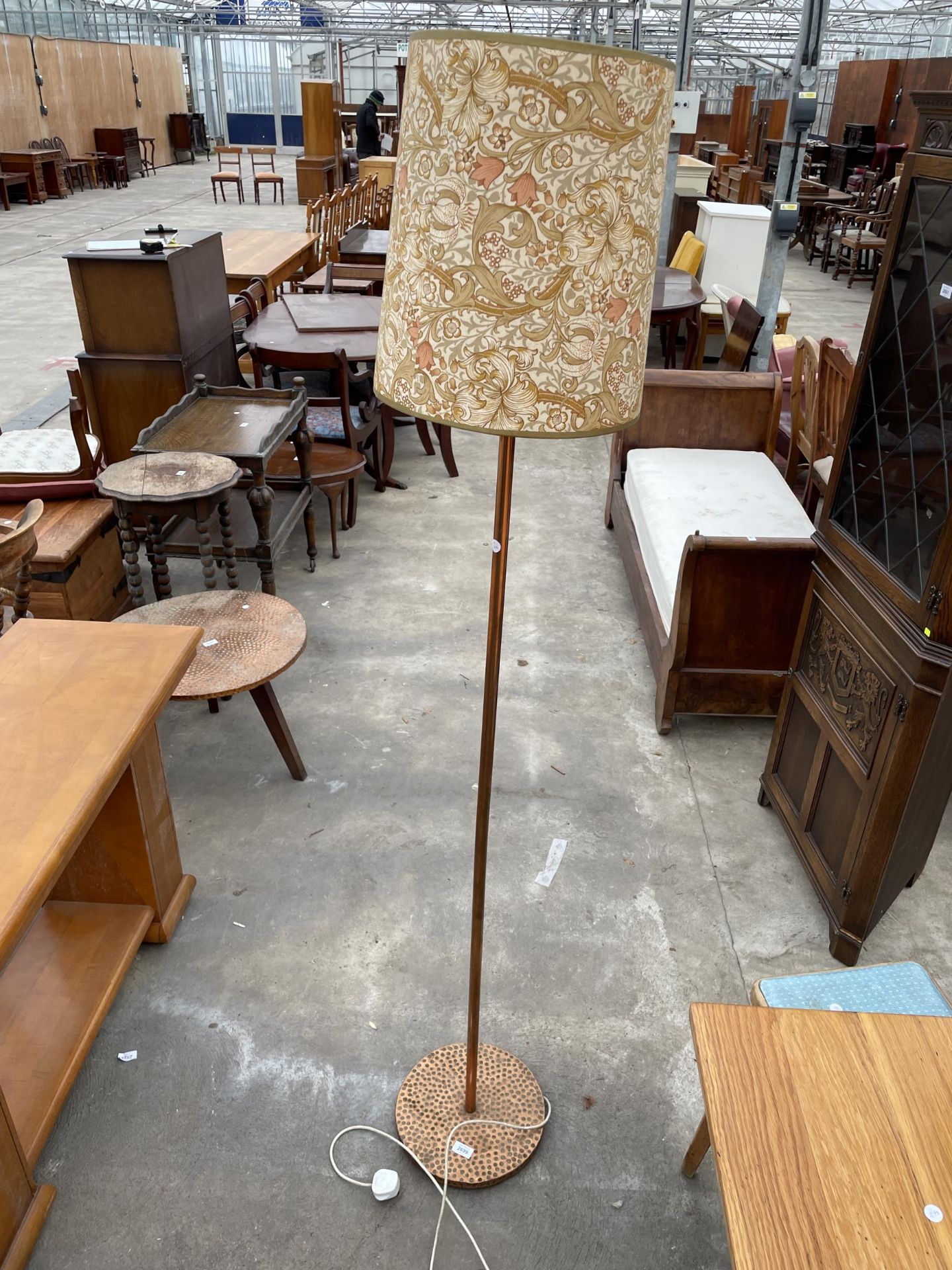 A STANDARD LAMP WITH COPPER BASE AND POLE COMPLETE WITH SHADE