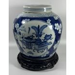 A LARGE CHINESE BLUE AND WHITE PRUNUS BLOSSOM 'OBJECTS' PATTERN PORCELAIN GINGER JAR ON CARVED