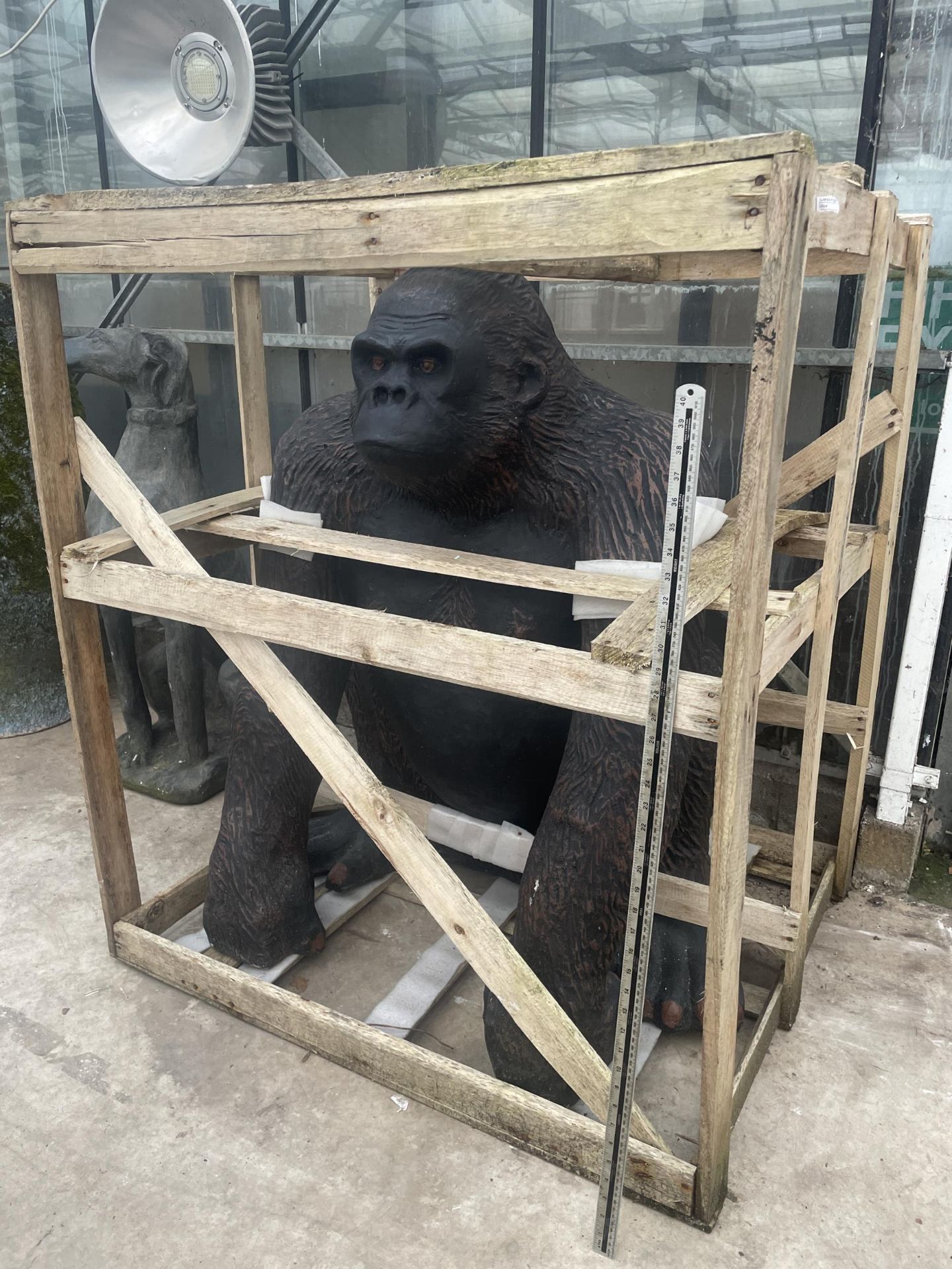 A LARGE FIBRE GLASS GORILLA GARDEN FEATURE (H:116CM W:96CM D:85CM)