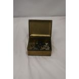 A BRASS BOX CONTAINING MILITARY BUTTONS AND BADGES