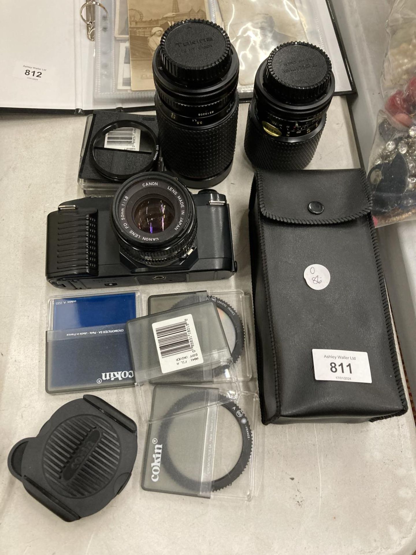 A CANON T50 CAMERA, 3 LENSES, ASSORTED FILTERS AND EXTRAS