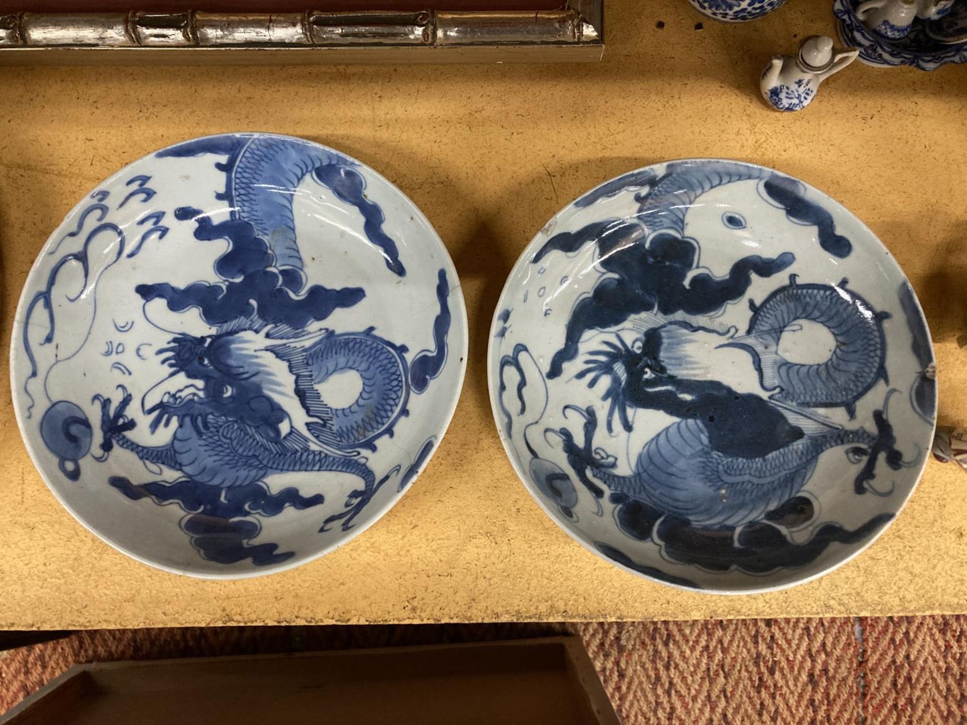TWO VINTAGE BLUE AND WHITE CHINESE BOWLS WITH DRAGON DESIGN