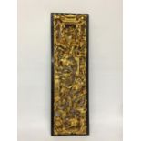 A CHINESE GILT CARVED LACQUERED WOODEN BATTLE SCENE PLAQUE PANEL