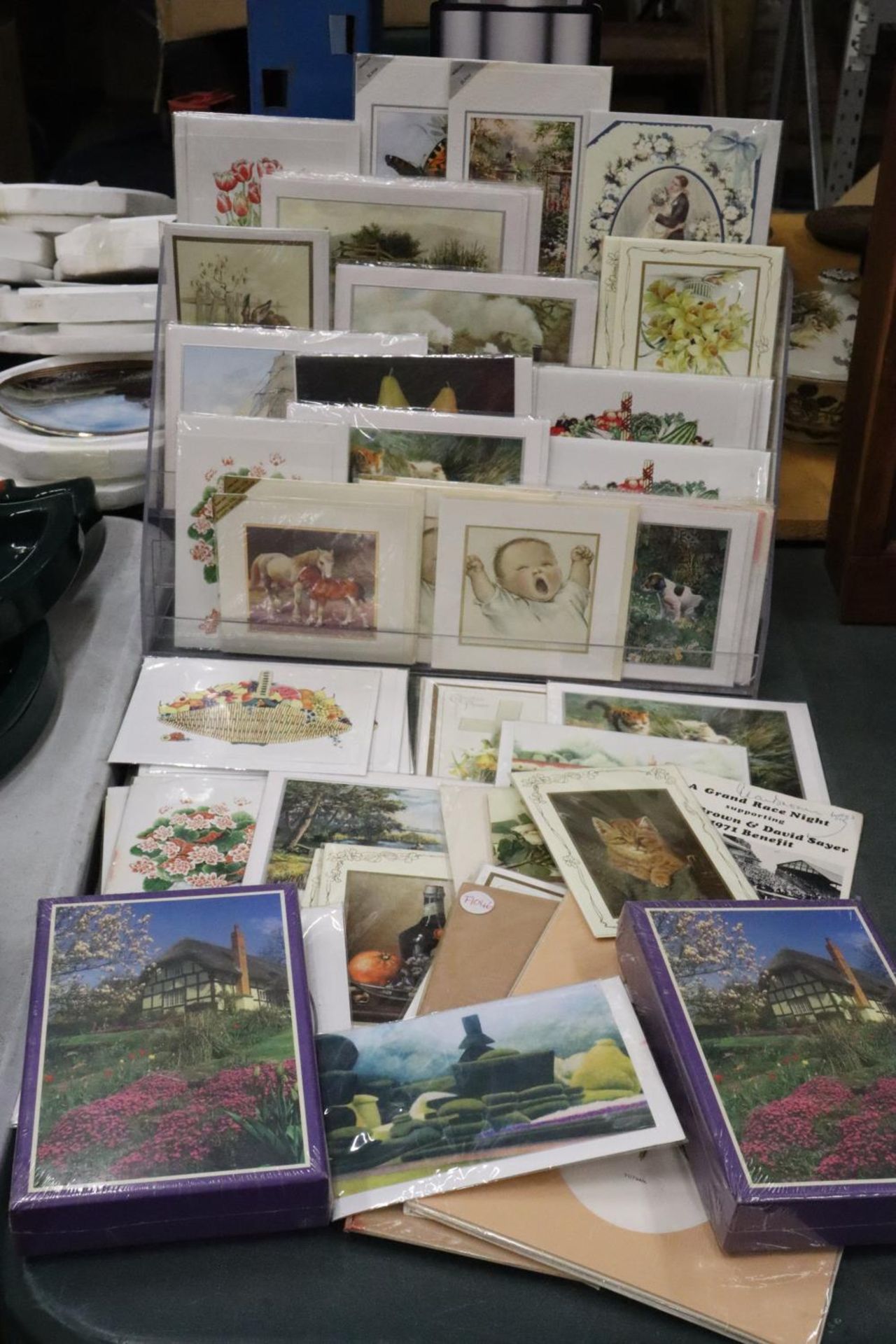 A QUANTITY OF ASSORTED GREETING CARDS WITH A DISPLAY STAND