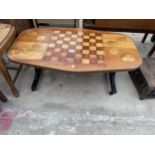 A RETRO TEAK COFFEE/GAMES TABLE WITH INLAID DRAUGHTS BOARD AND CARD SUITS