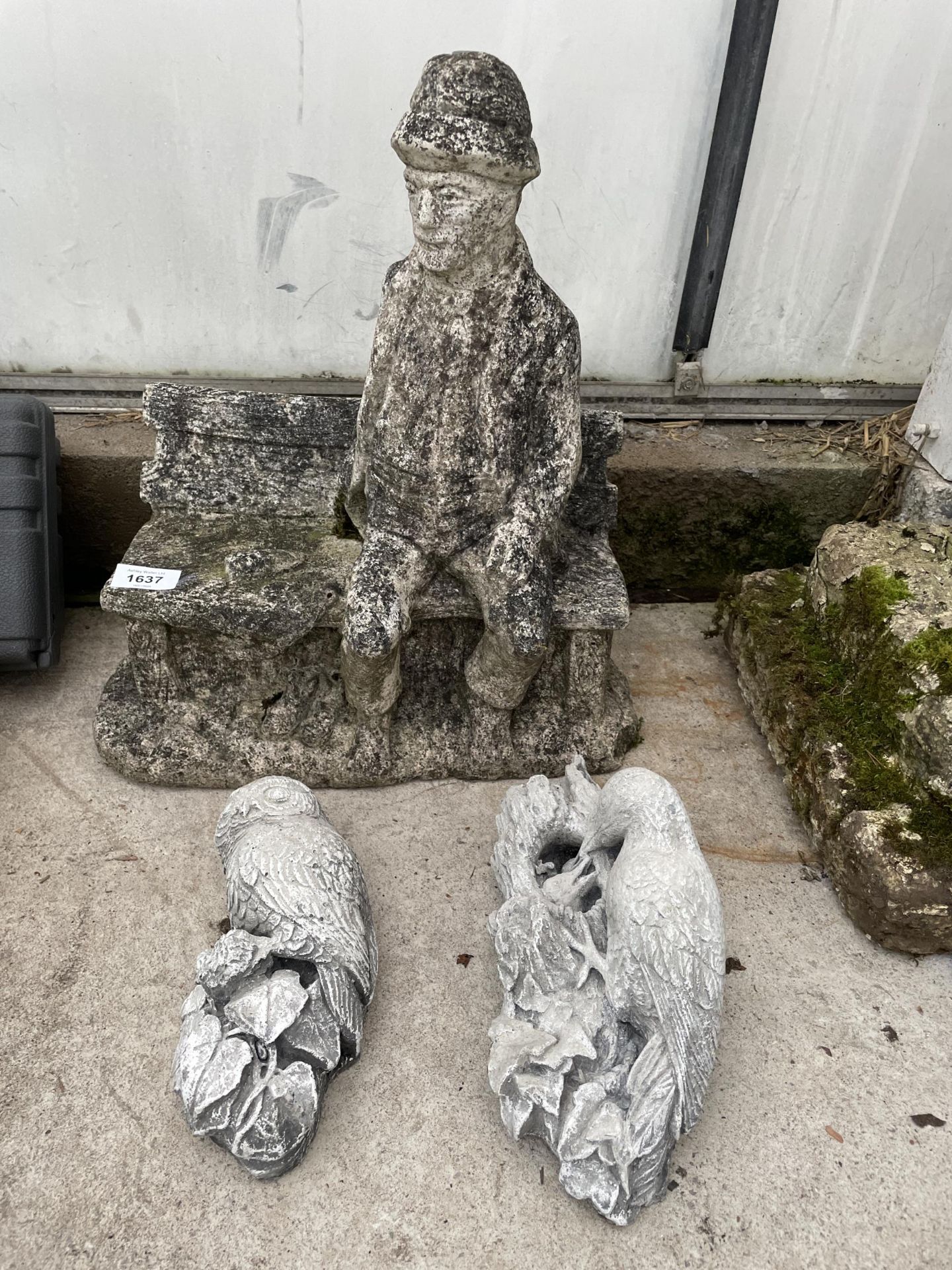 THREE CONCRETE GARDEN FIGURES TO INCLUDE A MAN SEATED ON A BENCH ETC