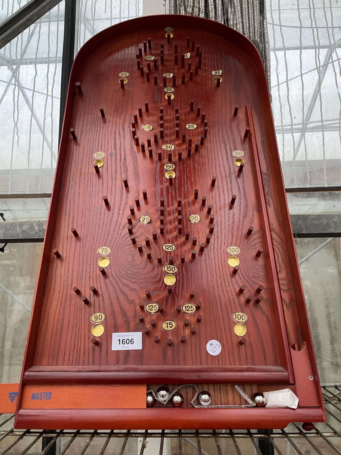 A VINTAGE WOODEN BAGATELLE GAME COMPLETE WITH BALLS