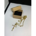 A NECKLACE WITH A CRYSTAL CROSS IN A PRESENTATION BOX