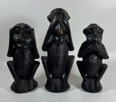 A SET OF THREE AFRICAN TRIBAL CARVED HARDWOOD EBONY EFFECT 'SPEAK NO, HEAR NO, SEE NO EVIL' MONKEYS,