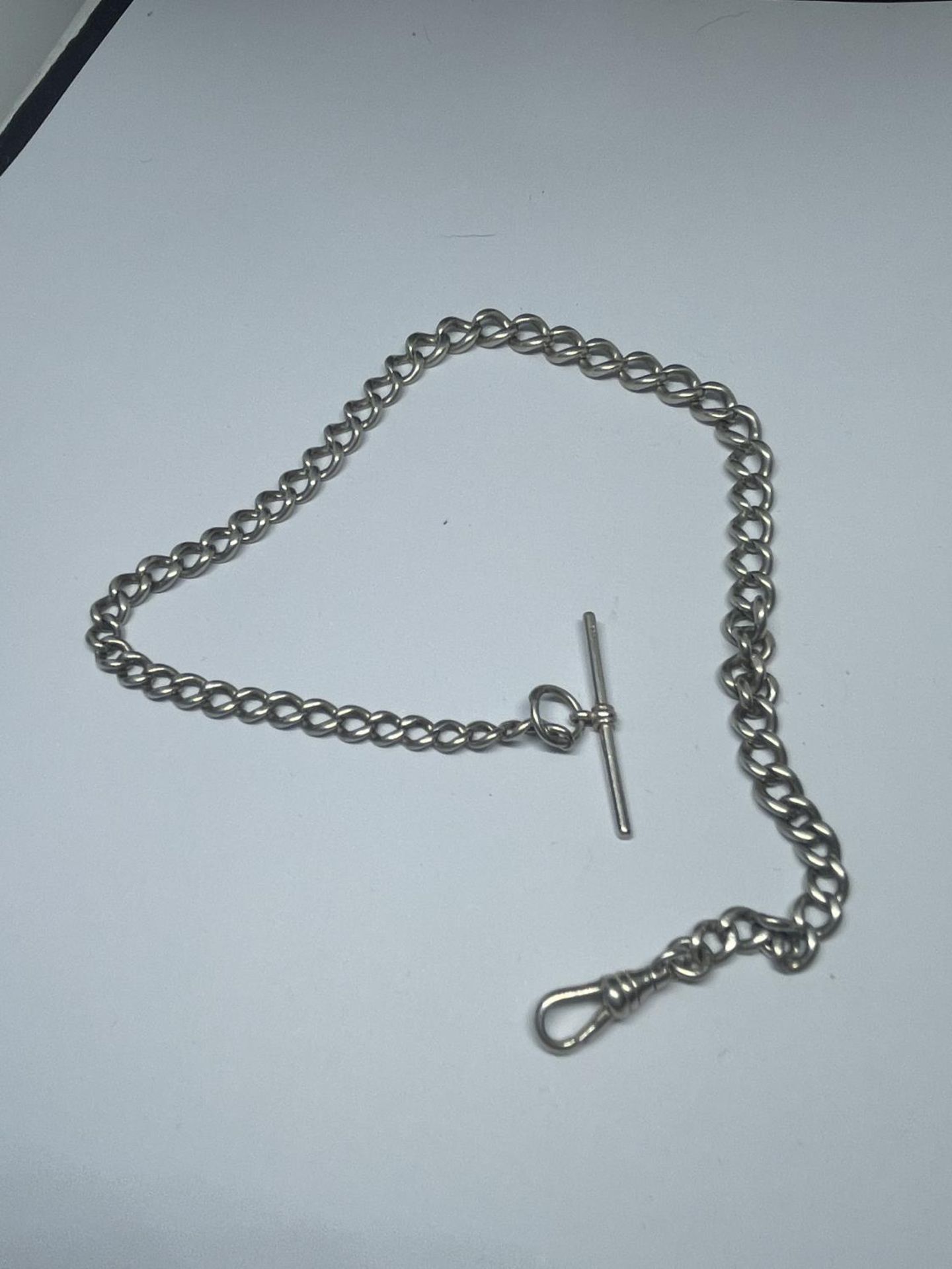 A SILVER POCKET WATCH CHAIN