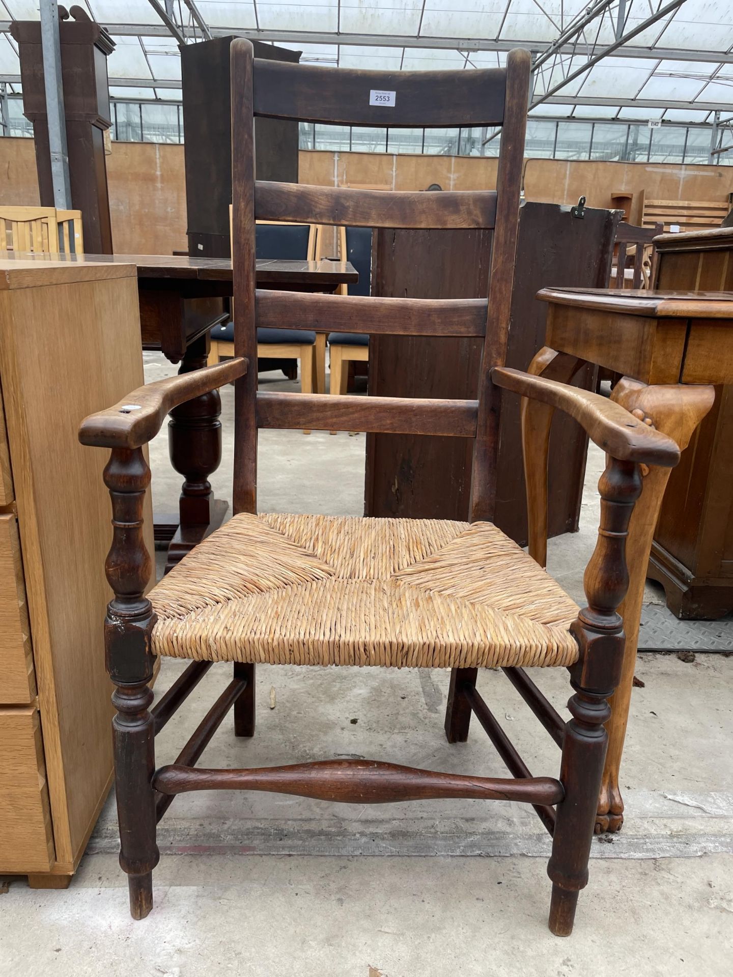A 19TH CENTURY LADDERBACK ELBOW CHAIR WITH RUSH SEAT - Image 2 of 4
